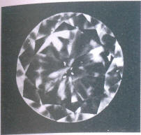 Fig 85 Several small crystal inclusions under the table and table facet 