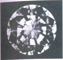 A crack-line indentation mark in pavilion facet edge seen through the crown 