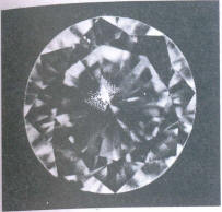 Fig 103 Rhombic shaped cloud under the table, light small crystals under crown main facet Fig 103 Rhombic shaped cloud under the table, light small crystals under crown main facet
