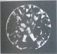 Fig 105 One larger and several smaller inclusions under the table, fringes Fig 105 One larger and several smaller inclusions under the table, fringes
