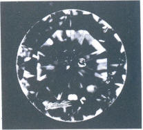 Fig 110 Cloud and cracks under the table. cleavage crack and light inclusions under crown facets Fig 110 Cloud and cracks under the table. cleavage crack and light inclusions under crown facets