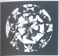 Fig61 Three very small light crystals under the table